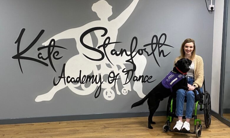 Kate Stanforth Academy of Dance written in stylish lettering with Kate on the right sat in her wheelchair in a dance studio