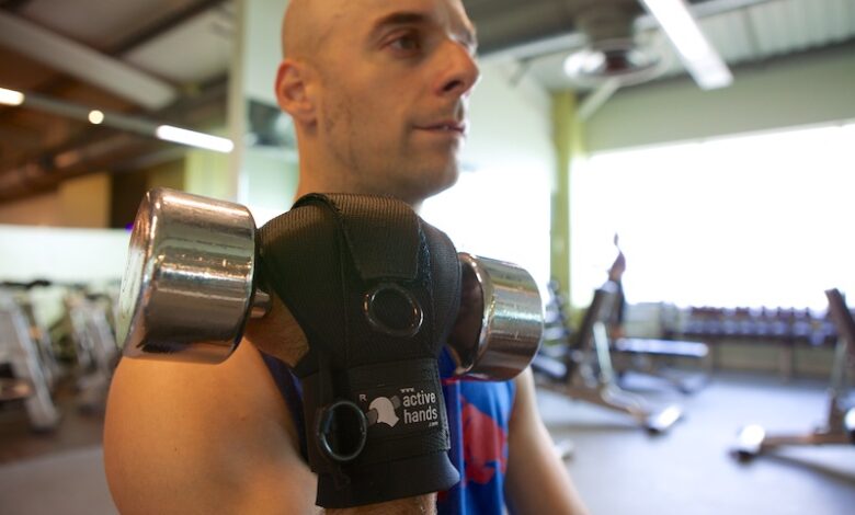 Rob Smith using general-purpose gripping aid to hold weight in gym