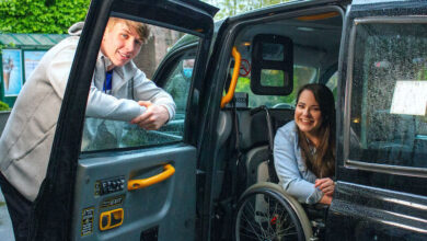Amy Conachan as Courtney in Hollyoaks sat in her wheelchair in a black cab