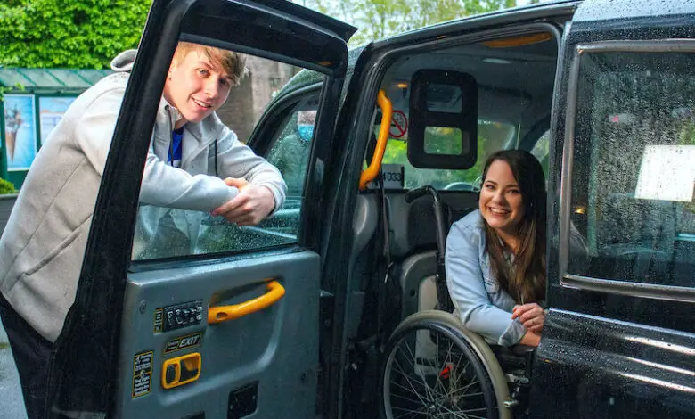 Amy Conachan as Courtney in Hollyoaks sat in her wheelchair in a black cab