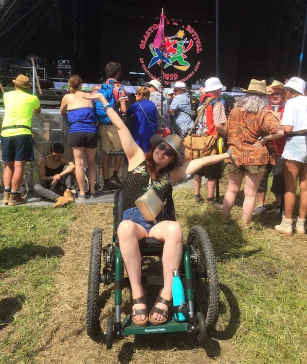 A woman in a Mountain Trike all-terrian wheelchair at Glastonbury festival