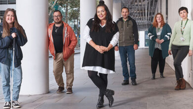 Scarlett Moffatt stood under a building with five young men and women who have Tourette's syndrome