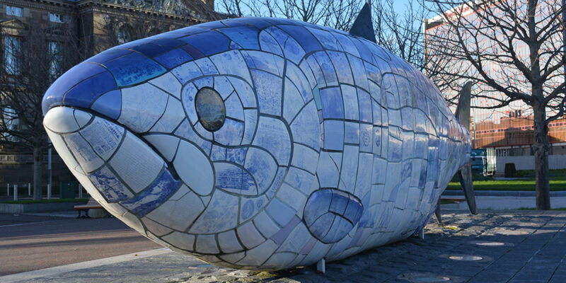 The Big Fish - a monument by John Kindness with each individual scale made of blue ceramic tiles capturing the city's history
