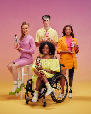 Group photo of the models holding the inclusive Barbie dolls