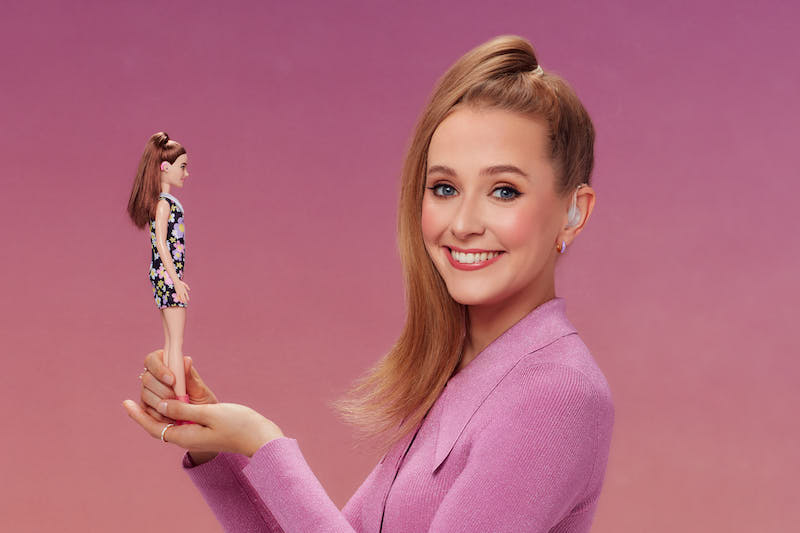 Rose Ayling-Ellis holding Barbie doll with hearing aids