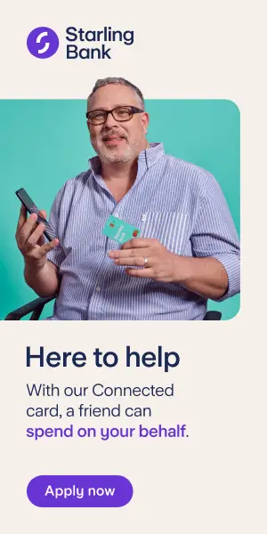 An older man with a grey beard and hair, black glasses and a lilac shirt, sat in a wheelchair holding a mobile phone and a Starling Bank card. Words above and below the image read 'Starling Bank' and 'Here to help. With our Connected card, a friend can spend on your behalf. Apply now'.