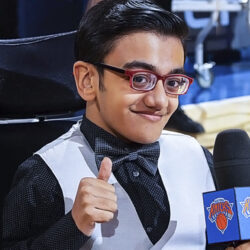 Sparsh Shah in evening attire, smiling at the camera and giving a "thumbs-up".