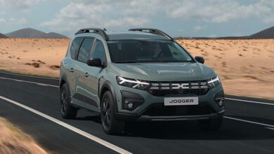 Darcia Rear Passenger wheelchair accessible vehicle in khaki green driving on a road