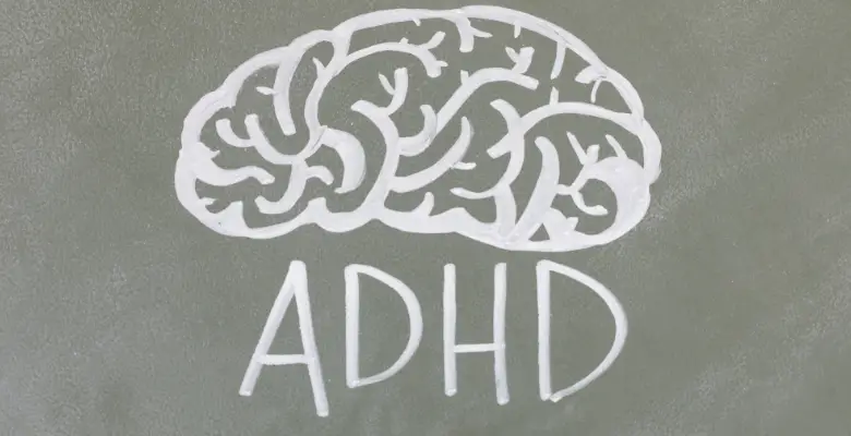 A drawing of a brain on a board with the letters ADHD in capitals underneath it