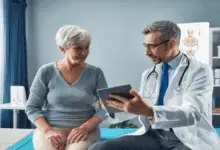 Doctor shows an older woman something on a tablet during a consultation in a medical office