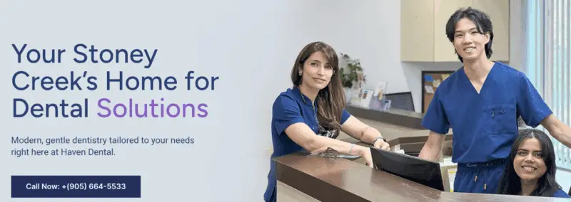 Three dental staff smiling at the front desk of Haven Dental, promoting gentle and modern dentistry.