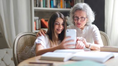 older woman showing something on her phone to younger girl (grand daughter?)