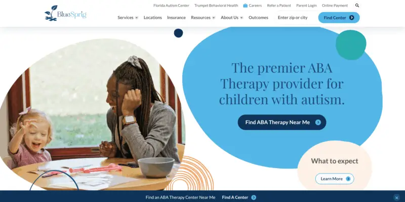 A therapist and young child smile and play at a table; text promotes ABA therapy for children with autism from BlueSprig.
