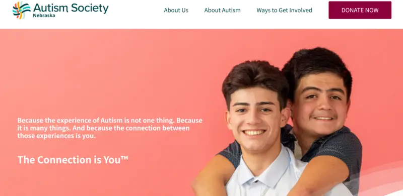 Webpage screenshot for Autism Society Nebraska. Two smiling teens hug in front of a pink background. Text reads: “The Connection is You™.”
