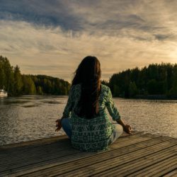 woman on a pier mediating