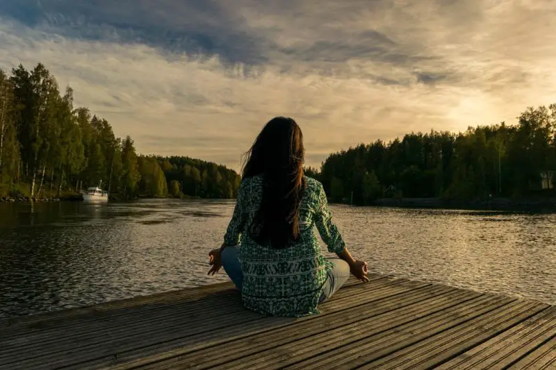 woman on a pier mediating