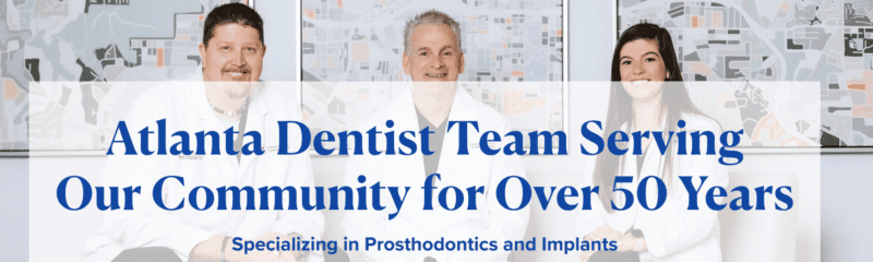 hree dentists in white coats smiling in front of maps, with text: “Atlanta Dentist Team Serving Our Community for Over 50 Years. Specializing in Prosthodontics and Implants.”