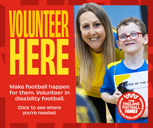 Poster with a woman and smiling boy in a football shirt beside bold yellow text: “Volunteer Here.” Text says: “Make football happen for them. Volunteer in disability football. Click to see where you’re needed.” Logo reads “England Football.”