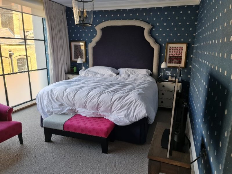 Accessible bedroom at Ham Yard Hotel with a large bed and space to manoeuvre around it.