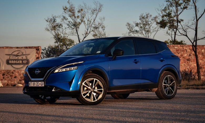 Blue Nissan Qashqai parked outdoors, viewed from the front and side.