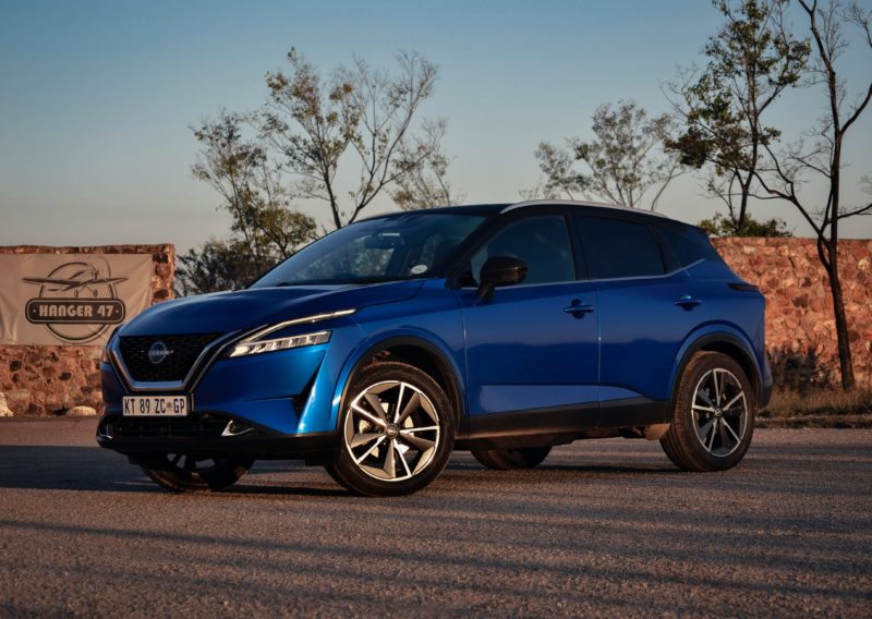 Blue Nissan Qashqai parked outdoors, viewed from the front and side.