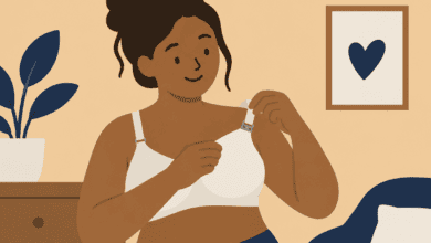 Disabled woman using one hand to adjust the clip on an adaptive nursing bra.