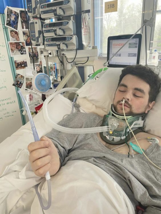 Disabled rapper Johkes lies in a hospital bed connected to breathing and monitoring equipment.