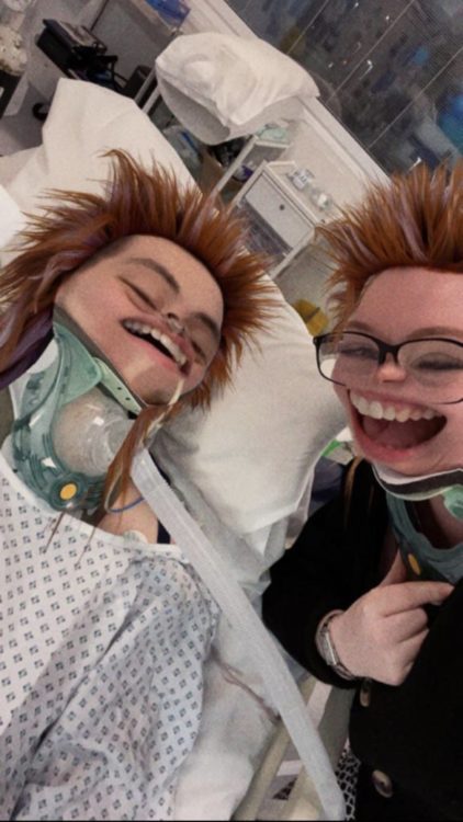 Susan and Johkes laugh together in a hospital room while a Snapchat filter gives them wild red hair and exaggerated faces.
